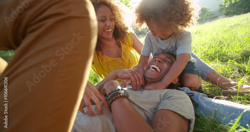 Stunning African-American family relaxing with eachother while laughing happily