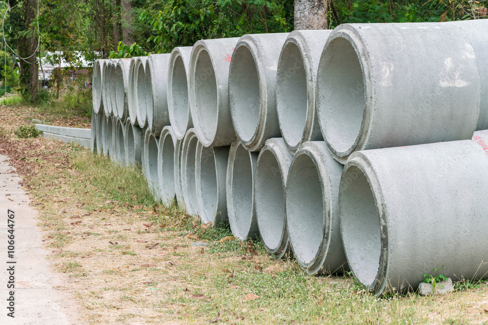 Concrete drainage pipes for industrial building construction stacked at roadside Concrete drainage pipes for industrial building construction stacked at roadside