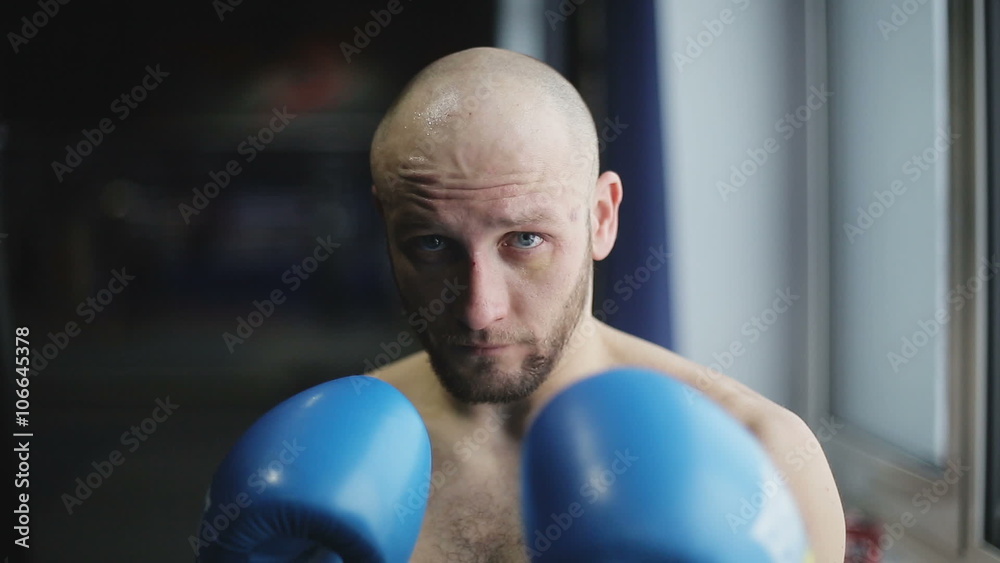 Portrait of strong man kickboxer doing self-defense and looking at camera Portrait of strong man kickboxer doing self-defense and looking at camera