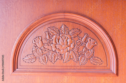 pattern of flower carved on brown wood background