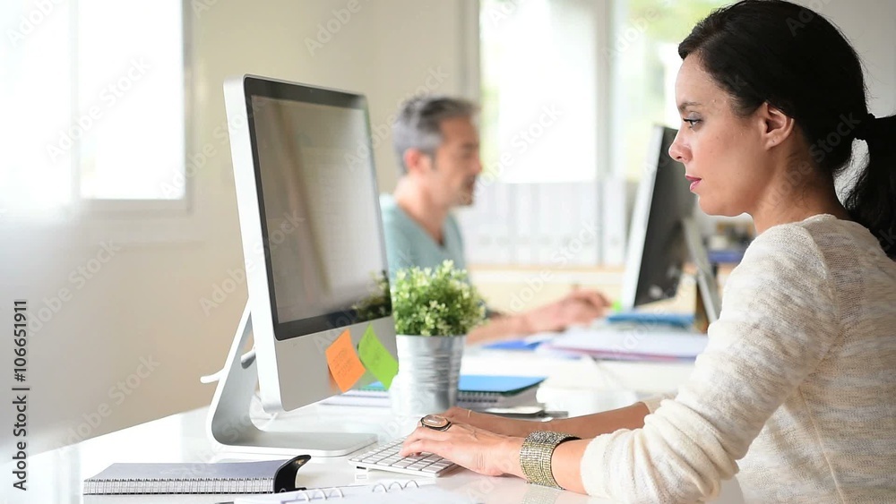 Co-workers in the office talking about project Co-workers in the office talking about project