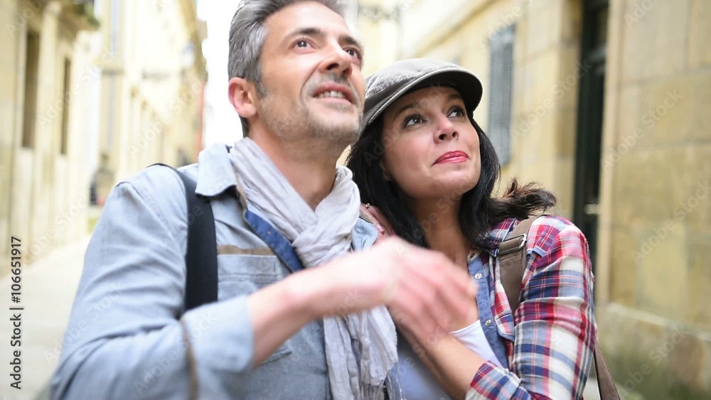 Couple of tourists walking in historical quarter of Spain Couple of tourists walking in historical quarter of Spain
