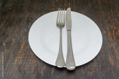 White plate, knife, fork 