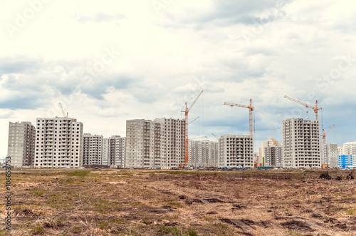Multistorey building and big cranes