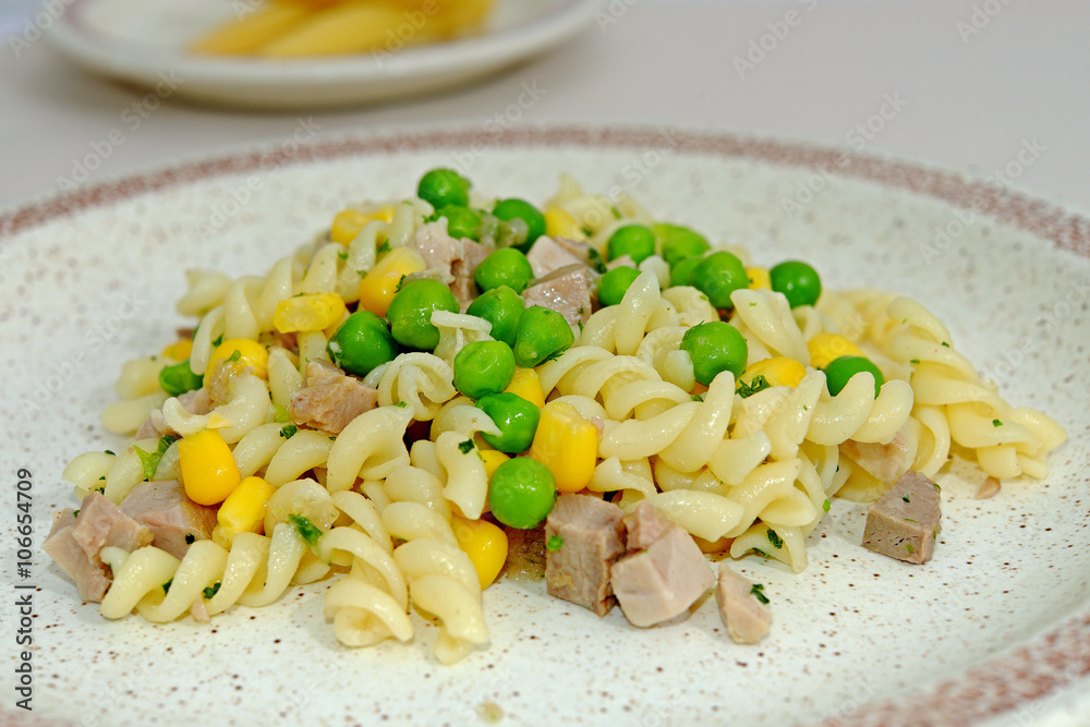 Homemade pasta with green peas corn and meat