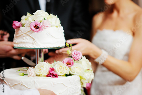 Cuadro en lienzo Bride and groom cutting a wedding cake