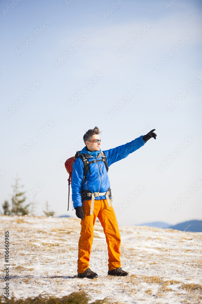 The man with the backpack shows the direction.