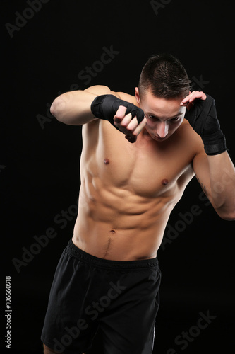 Shirtless man with boxe gloves training