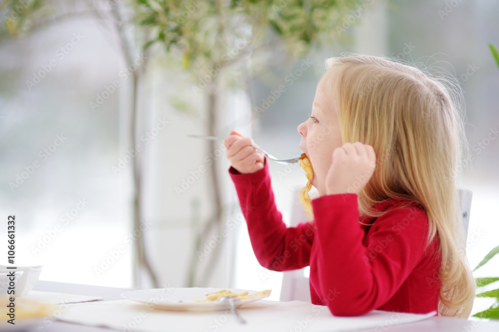 Cute little girl having crepes for breakfast Cute little girl having crepes for breakfast