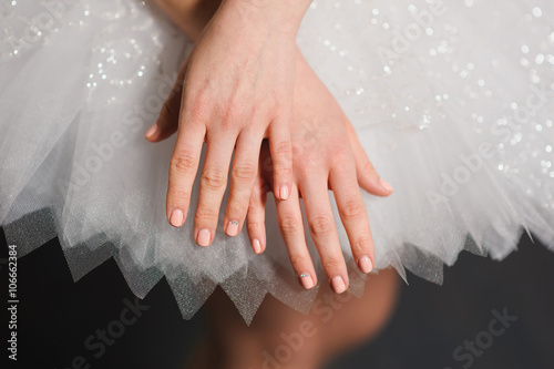 Hands of ballerinas with her tutu.