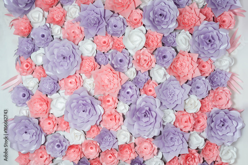 Colorful paper flowers background. Floral backdrop with handmade roses for wedding day or birthday.