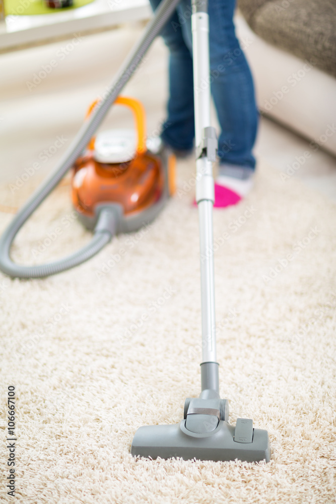 Vacuuming carpet with vacuum cleaner Stock Photo | Adobe Stock