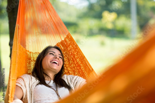 Cheerful girl enjoy in hammock photo