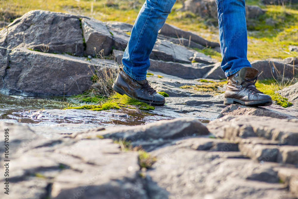 guy in uncomfortable shoes stepping on stones guy in uncomfortable shoes stepping on stones
