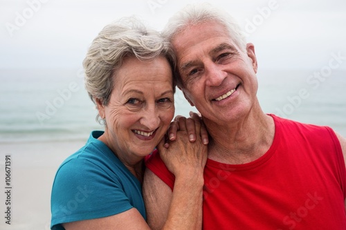 Happy senior couple embracing each other on the beach