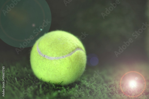 Healthiness concept and sport background idea, tennis ball on the green grass © smshoot