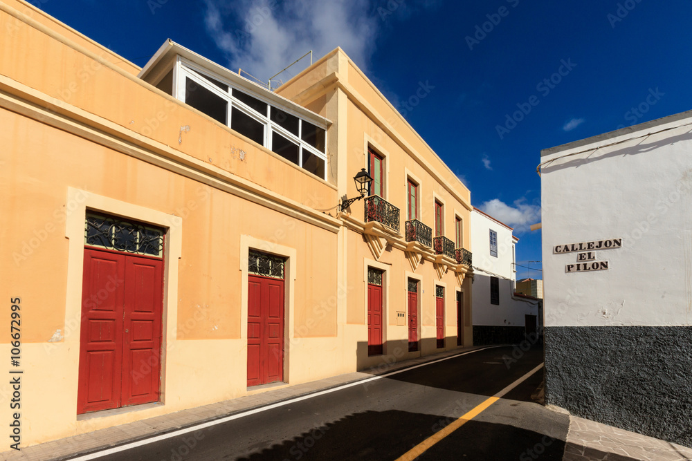 Fototapeta premium Summer cityscape on tropical island Tenerife, Canary in Spain. Street of old town Guia de Isora.