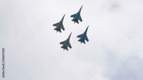 Four fighter planes together in sky