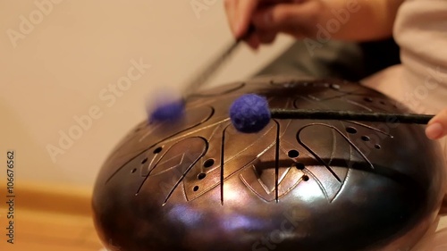 playing on the steel tongue drum photo