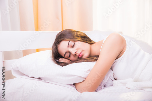 Woman sleeping. Beautiful young smiling woman sleeping in bed