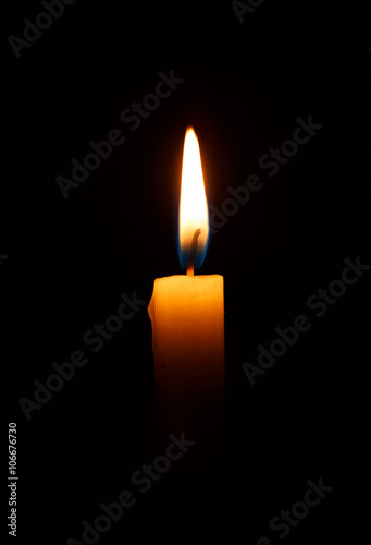 One light candle burning brightly in the black
