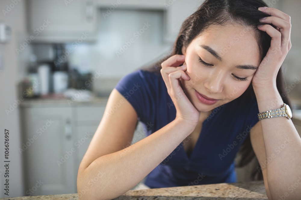 Young woman daydreaming in kitchen Young woman daydreaming in kitchen