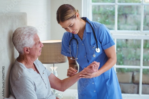 Nurse examining senior man  photo