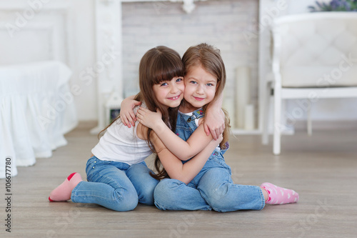 little girls hugging and laughing
