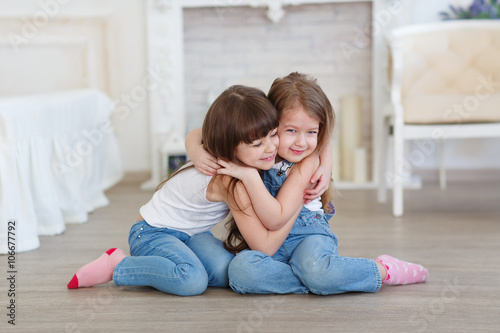 little girls hugging and laughing