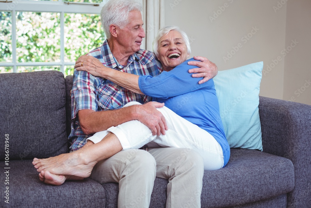 Romantic senior couple sitting on sofa