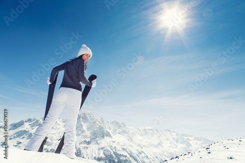 Young woman with ski on mountains