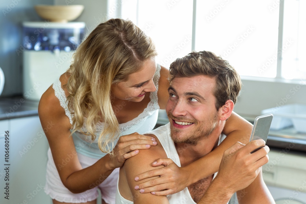 Fototapeta premium Loving couple looking at each other in kitchen
