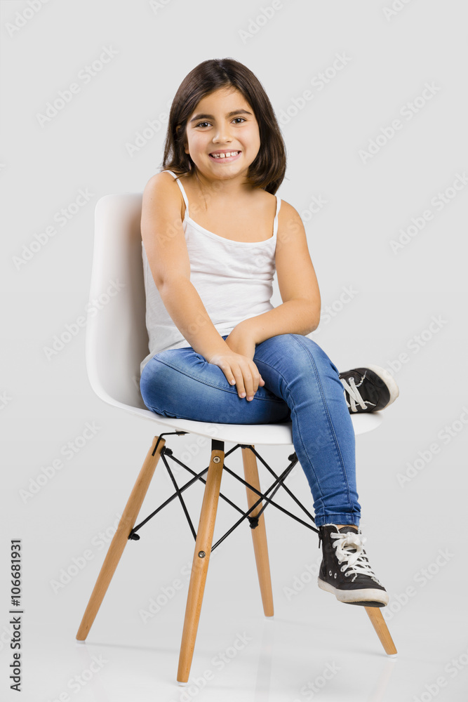 Beautiful young girl sitting on a chair Beautiful young girl sitting on a chair