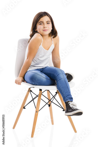 Beautiful young girl sitting on a chair