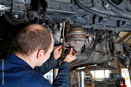 car mechanic is repairing the motor of a car