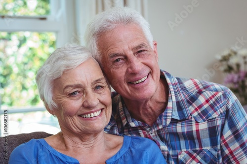 Happy loving senior couple on sofa