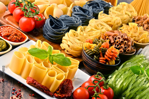 Composition with variety of pasta on kitchen table