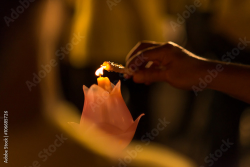 Hand lighting a candle
