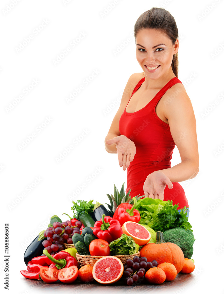 Young woman with variety of organic vegetables and fruits Young woman with variety of organic vegetables and fruits