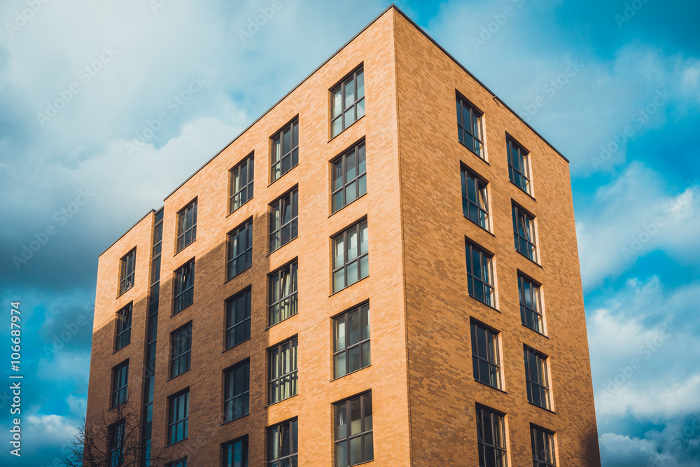 Apartment building with shadow under blue sky