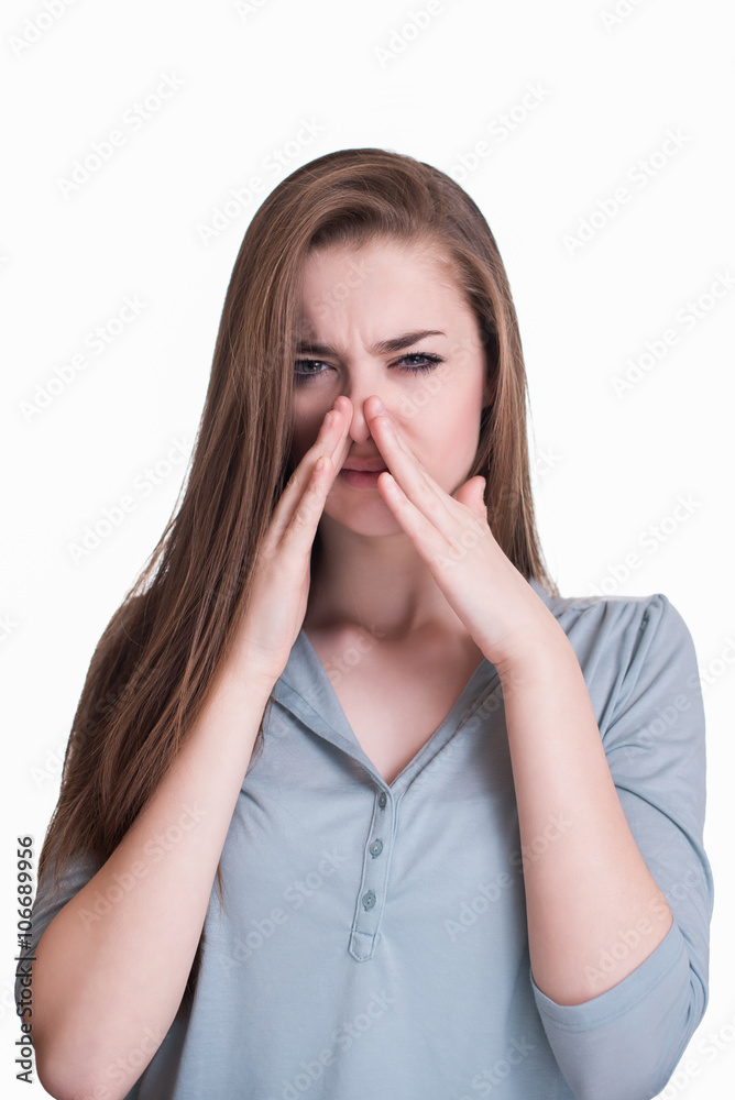 Young woman closes her nose because of the smell Young woman closes her nose because of the smell