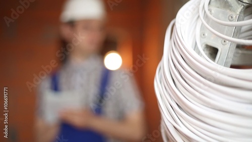 Electrician on the background of the cable photo