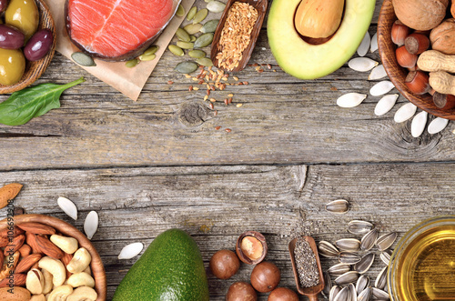 Selection of healthy fat sources on wooden table. Copyspace background. Top view. 