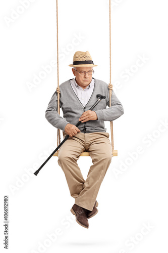 Lonely senior sitting on a swing