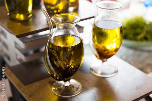 close up of glass jug with extra vergin olive oil photo