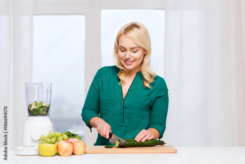 smiling woman with blender cooking food at home