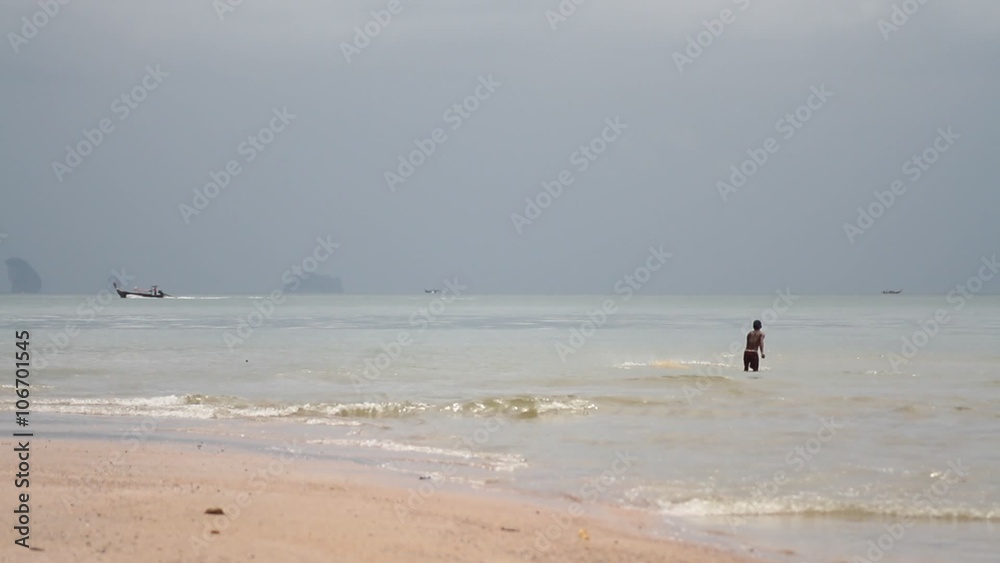 fisherman with nets in the background longtail boat floats. Ao Nang beach, Krabi, Thailand
fisherman with nets in the background longtail boat floats. Ao Nang beach, Krabi, Thailand