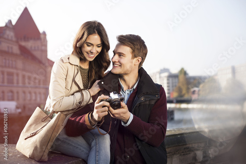 Germany, Berlin, young couple looking at camera at bank of River Spree