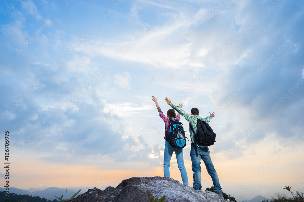 Couple of hikers on the top of mountain. Travel concept Couple of hikers on the top of mountain. Travel concept