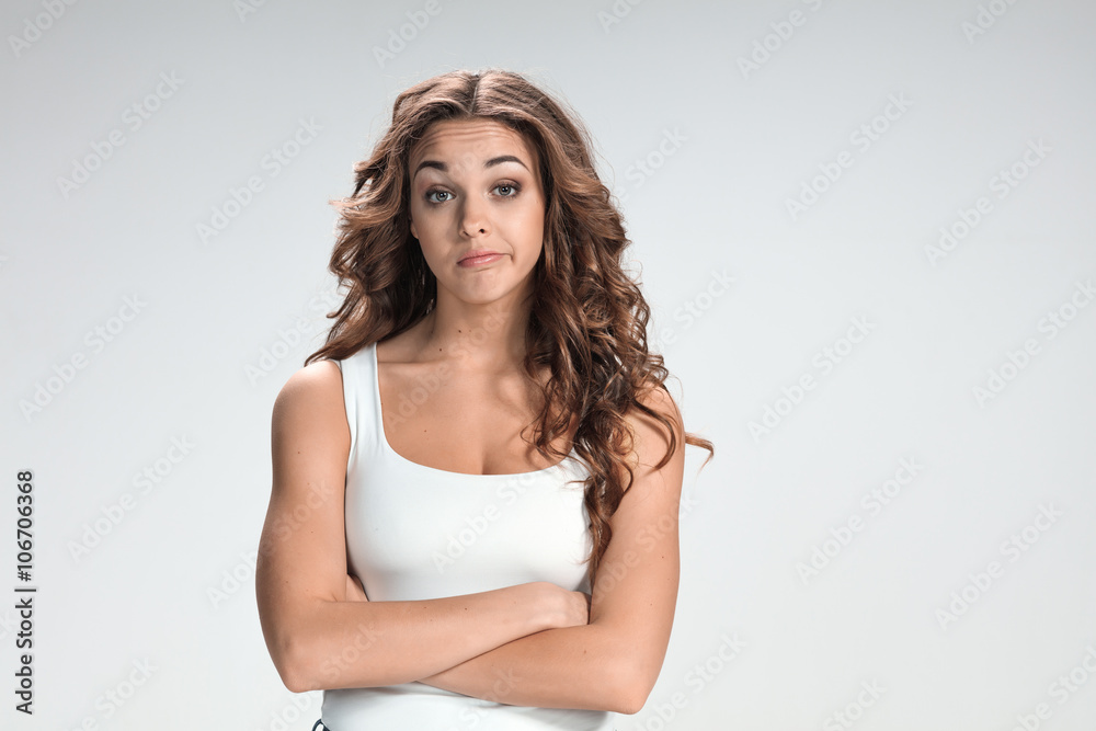 The happy thoughtful woman on gray background The happy thoughtful woman on gray background